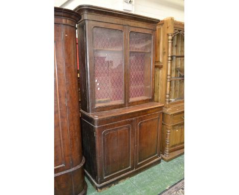 A Victorian bookcase cabinet, outswept cornice, two arched glazed doors to top, projecting base, moulded top, two door cupboa