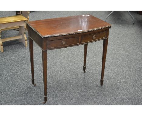 A mahogany bow fronted hall table, two short drawers to frieze, tapering square supports, spade feet, ceramic casters.