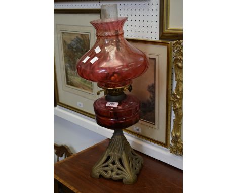 A Victorian cranberry glass oil lamp