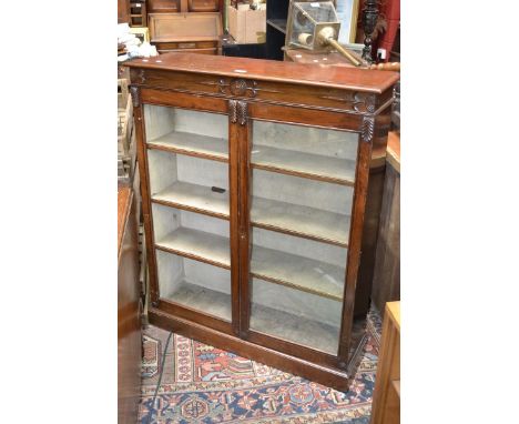 A mahogany bookcase, moulded top, two glazed doors enclosing shelving, plinth base, circa 1850