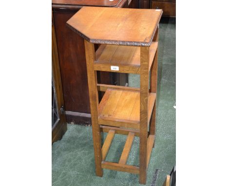 A mid-20th century oak corner bookcase table