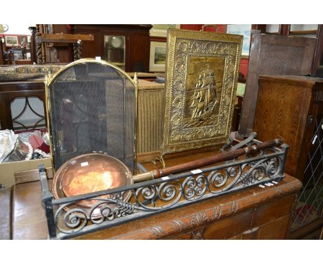 An iron fender; an iron candlestick; fire screens; a copper warming pan (5)