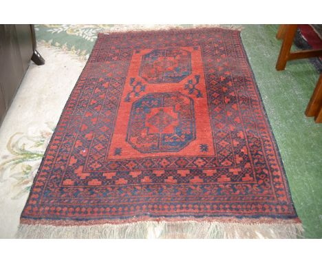 A Hand woven Middle Eastern carpet in shades of red and blue early 20th century, 150cm x 100cm