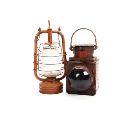 Two Oil Lamps by English Makers,  comprising a 'Railway Lamp' by C J Davis South London Lampworks with dark red body and red 