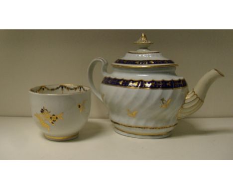 A Barr Worcester tea pot and cover together with an earlier bowl, the fluted body of the first gilt with vines on blue bands 