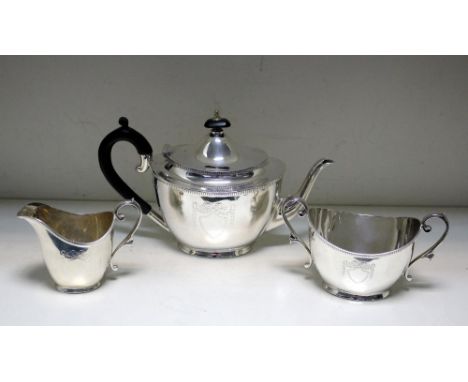 A silver three piece bachelor's teaset, by Roberts and Belk, Sheffield 1916, comprising:- a teapot of tapering oval form belo