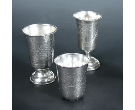 Three Russian silver vodka cups, comprising a small beaker Moscow 1882, by Israel Eseevich Zakhoder, assay master A.K, 5cm, f