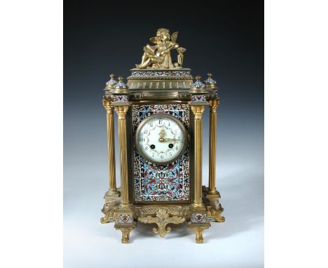 A 19th century French ormolu and champleve enamel mantle clock, the architectural case with reeded columns and surmounted by 