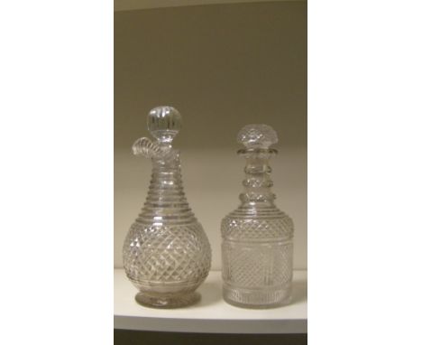 A George III glass carafe, possibly Waterford and a decanter with stoppers, the first with a lip above a ring cut neck flarin