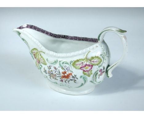 A patch marked Derby sauce boat moulded below the gadrooned rim with flowers and pairs of figs, the rococo mouldings painted 