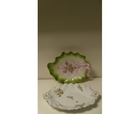 A Bow leaf shaped dish together with a Chelsea Red Anchor dish, the first painted with flowers centrally to its mauve ribbing