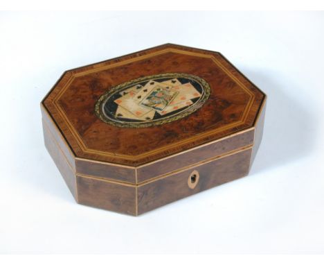A 19th century yew wood card box, the crossbanded hinged cover with centrally painted cartouche of playing cards 5 x 18 x 15c