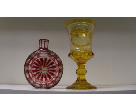 A Bohemian ruby overlay glass flask and an amber overlay goblet, the compressed spherical shape of the first and the thistle 