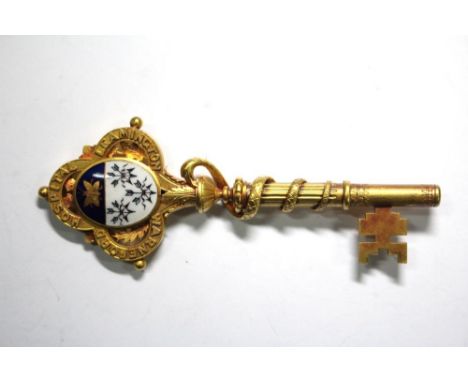 A Victorian yellow metal and coloured enamel presentation key, unmarked, relating to the opening of new buildings at Warnefor