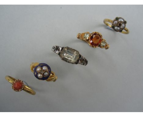 A hessonite garnet and chrysoberyl ring and four other 19th century gem set rings, the first with an oval cut hessonite betwe