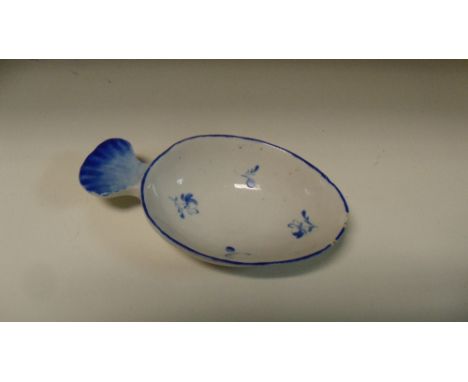 A Derby overglaze blue feeding or caddy spoon painted with flower sprigs within the blue lined rim with shell handle to one e