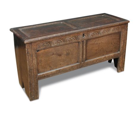 A small 17th century oak chest, with panelled top, carved frieze rail, on bench end supports 66 x 120 x 42cm (26 x 47 x 16in)