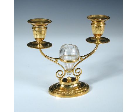 A Victorian electrogilded twin light candelabrum, by Elkington & Co, date code for 1889, raised from an oval foot with laurel