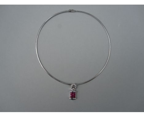 An Italian ruby and diamond pendant necklace, the pendant designed as a square of mystery set calibré cut rubies with polishe