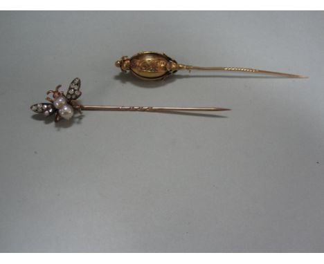 A 19th century gem set insect stickpin together with an ovoid finial stickpin, the first set with a double pearl thorax, old 
