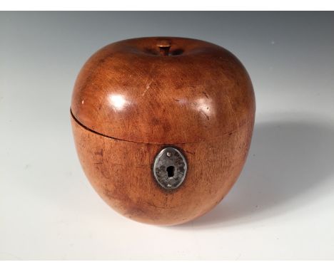 A turned fruitwood apple shaped tea caddy, with oval escutcheon, the hinged top with a stalk 11cm (4in)