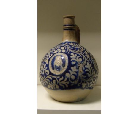 A William III Westerwald jug, the near spherical body with a relief portrait oval of the monarch opposite the handle, flanked