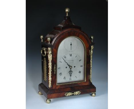 A Regency mahogany bracket clock, the arched case with brass ball topped pyramid cresting, and four finials, gilt metal carya