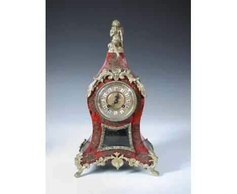 A late 19th century Boullework mantle clock, the waisted case surmounted with seated Cupid above 8.5cm gilt dial having inset