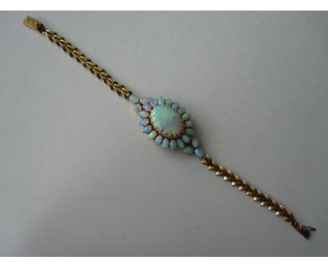 An opal set fancy chain bracelet, the central cluster designed as a large flowerhead of oval cabochon opals of predominantly 