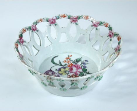 A Worcester basket, the wavy rim painted with alternating red flowers and pink roses above guilloche piercing and central bun