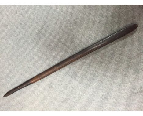 An Aboriginal hardwood digging stick or club of slender oval section, the sides poker worked with stylised reptilian skin dec