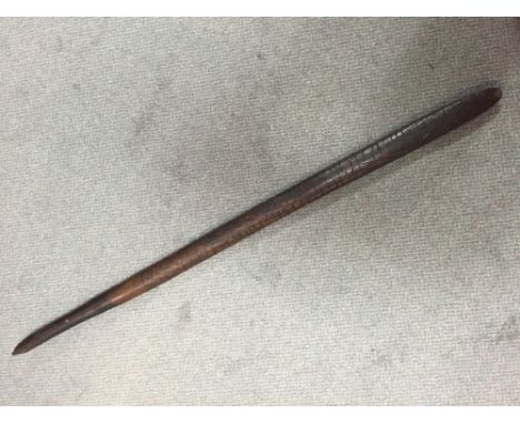 An Aboriginal hardwood digging stick or club of slender oval section, the sides poker worked with stylised reptilian skin dec