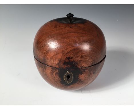 A turned fruitwood apple shaped tea caddy, with oval brass escutcheon, the hinged top with a stalk 12cm (5in)
