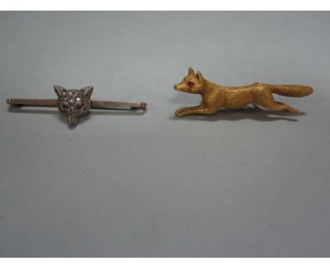 Two fox brooches, the first a realistically modelled and textured running fox with round cut ruby eyes, clasp with safety pus