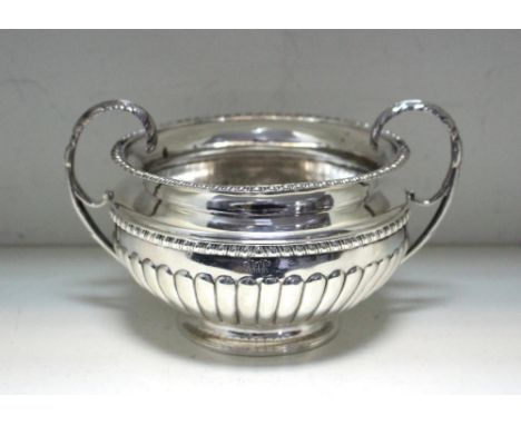 An Irish silver sugar basin, by Charles Marsh, Dublin 1816, of compressed circular form, the lower body fluted below a gadroo