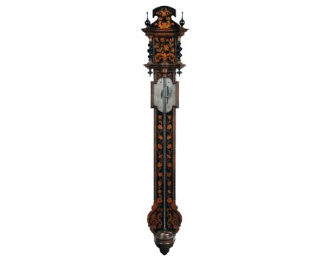 A walnut marquetry stick barometer in the late 17th century style, the shaped engraved silvered register below two twist colu