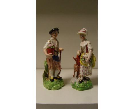 A pair of Derby figures of gardeners, he stands holding a pot of flowers a spade handle in his left hand, she with flowers in