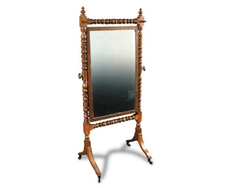 A late Regency mahogany cheval mirror, with bobbin turned frame, on swept legs with ebony line inlay and brass casters 147 x 