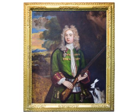 English Provincial School  (early 18th Century) Portrait of a gentleman with his spaniel standing in a landscape with a woodc