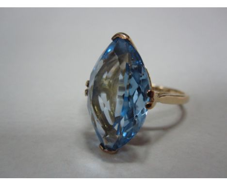 A single stone pale blue spinel ring, the marquise cut spinel, possibly of synthetic origin, claw set at the cardinal points 