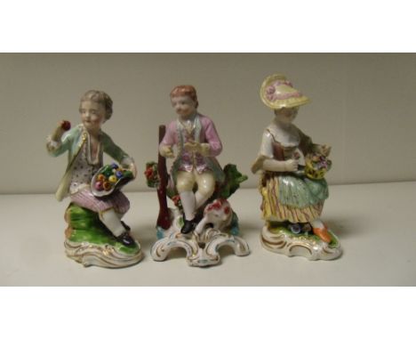 A pair of and a single Derby seated figure, the pair seated on rococo bases, she with a basket of flowers on her lap, he with