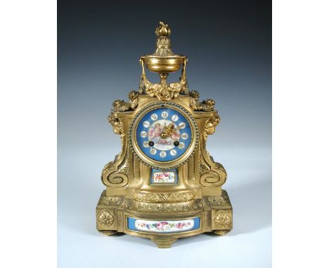 A 19th century French ormolu and porcelain mounted mantle clock by Le Rolle Freres, the urn topped case above enamel dial pai