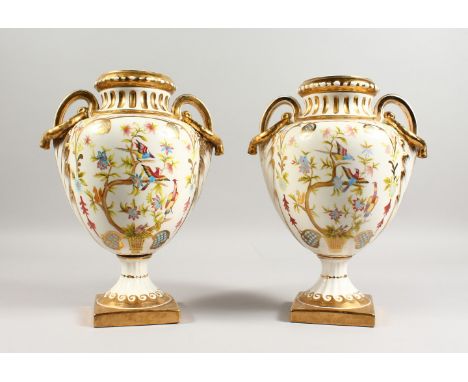 A PAIR OF SEVRES STYLE URN SHAPED TWIN-HANDLED VASES, decorated with birds. 12.5ins high.