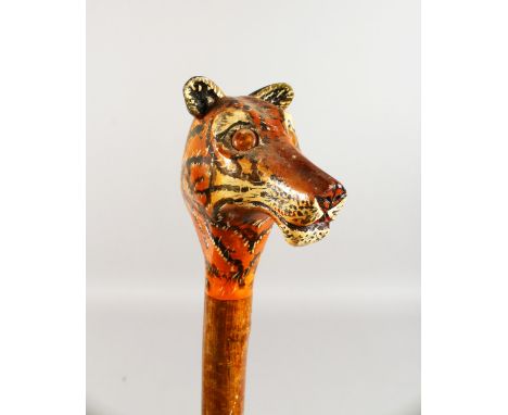 A WALKING STICK, the handle carved as a tiger. 52ins long.