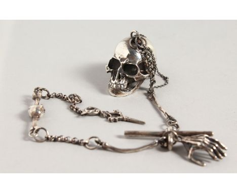 A CAST SILVER SKULL SNUFF BOX, on a chain depicting bones.