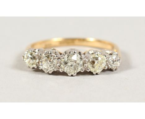 AN 18CT GOLD AND PLATINUM MOUNTED FIVE STONE DIAMOND RING of 1.2CTS.