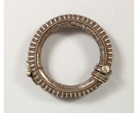 AN EASTERN WHITE METAL BANGLE. 3.5ins diameter.
