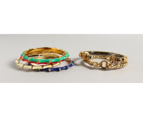SIX ENAMEL DECORATED GILT METAL BANGLES. 3ins diameter.