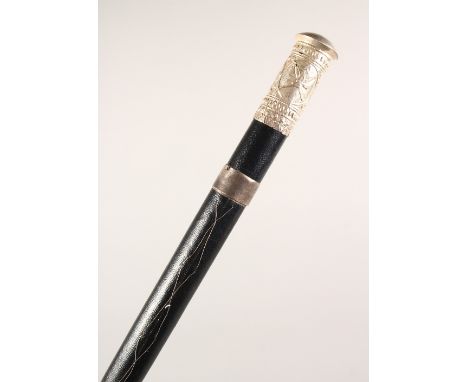 A BLACK LEATHER COVERED WALKING STICK, with eastern white metal mounts. 36ins long.