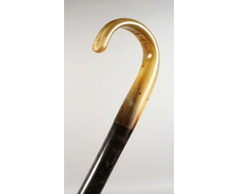 A HORN HANDLED EBONY WALKING STICK. 34.5ins long.